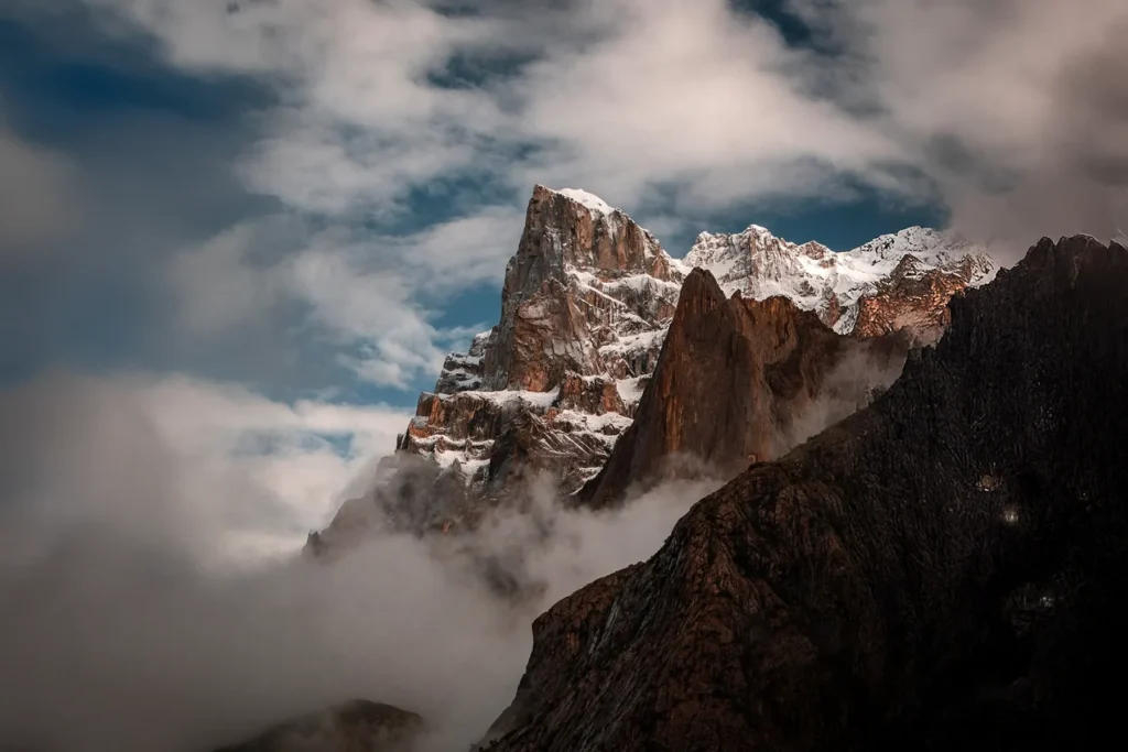 Granite spires rising through drifting cloud in the Karakoram, on the Nangma Valley trek